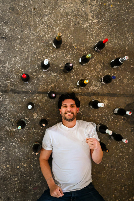 Davide von Raum & Wein mit Weinflaschen – persönliche Weinberatung in der Frankfurter Vinothek